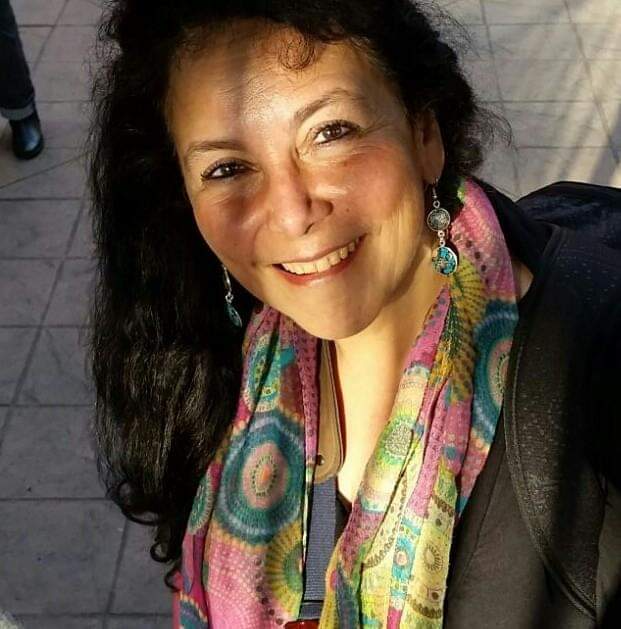 mabel smiling at the camera standing in the sun